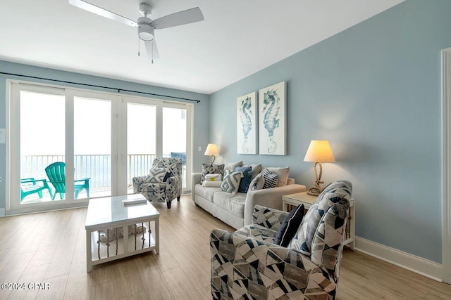 living room with ceiling fan and light wood-type flooring