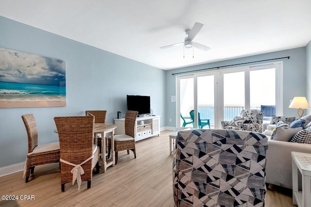 living room featuring ceiling fan and light wood-type flooring