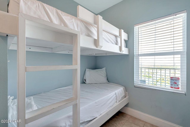 tiled bedroom with multiple windows