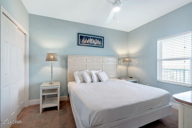 carpeted bedroom featuring a closet and ceiling fan