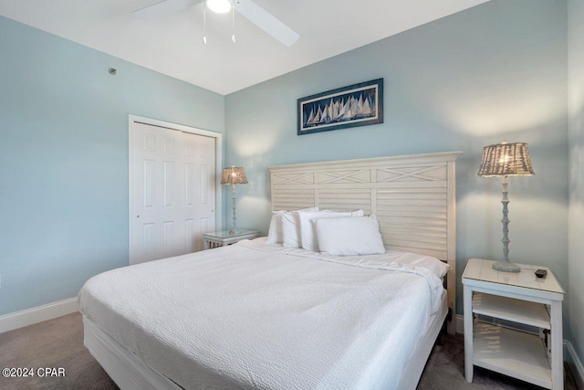 carpeted bedroom with ceiling fan and a closet