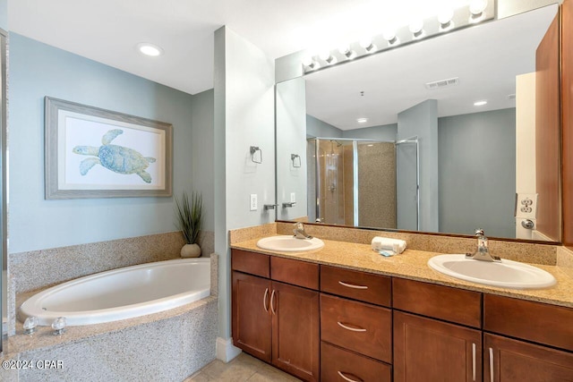 bathroom with tile patterned floors, vanity, and separate shower and tub