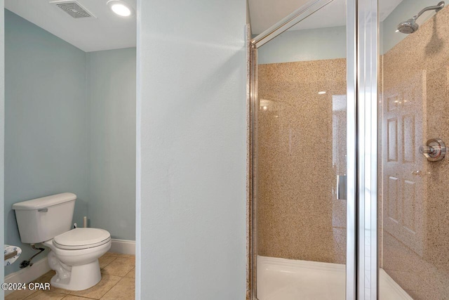 bathroom with tile patterned floors, toilet, and walk in shower