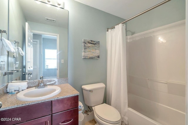 full bathroom with vanity, shower / bath combo, and toilet