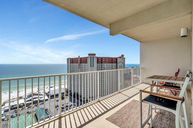 balcony featuring a beach view and a water view