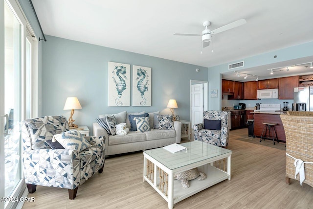 living room featuring ceiling fan, track lighting, and light hardwood / wood-style flooring