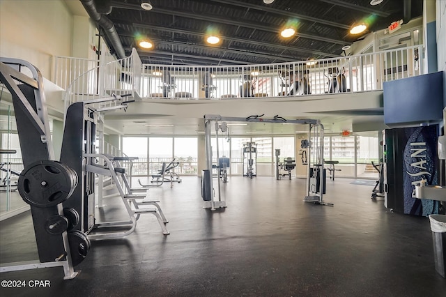 workout area featuring a towering ceiling