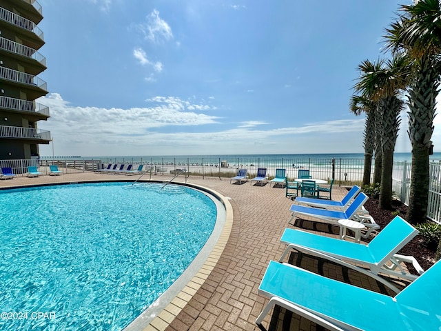 view of pool featuring a water view