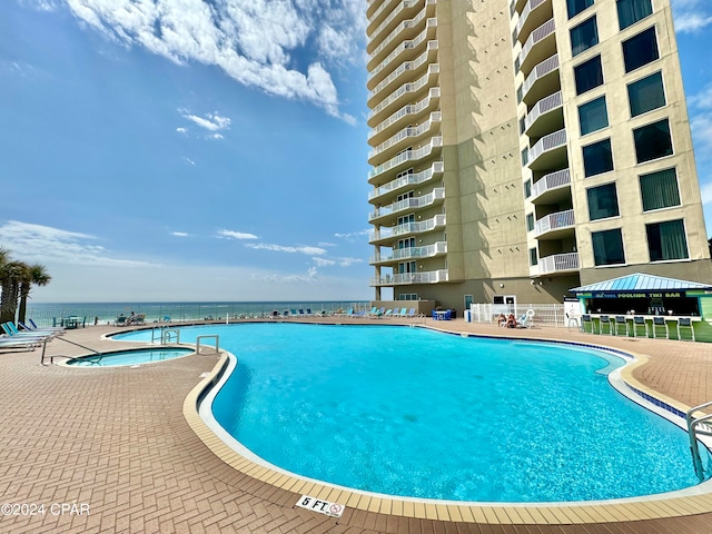 view of pool featuring a water view and a gazebo