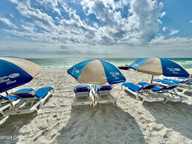 exterior details featuring a water view and a view of the beach