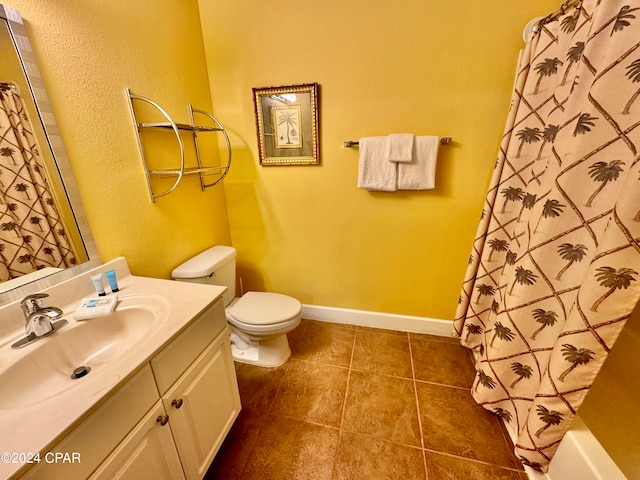 bathroom with tile flooring, toilet, and vanity with extensive cabinet space