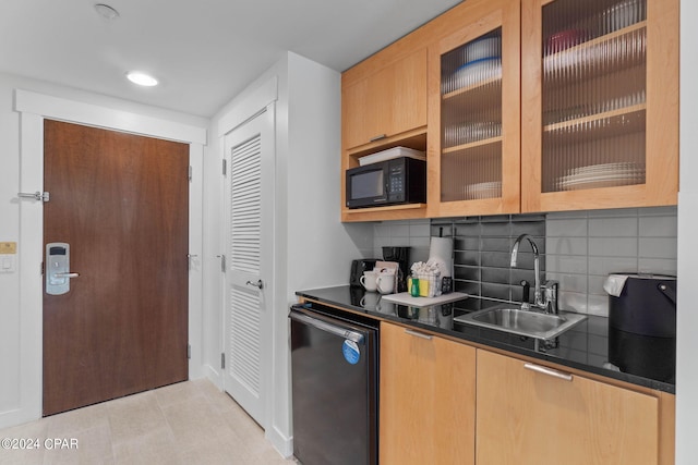 kitchen featuring decorative backsplash, sink, black appliances, and light tile patterned floors