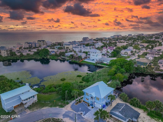 aerial view at dusk with a water view