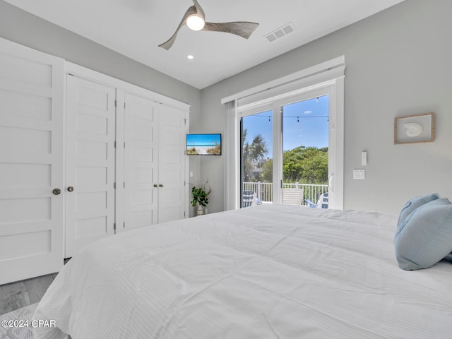 bedroom featuring access to exterior, light hardwood / wood-style flooring, and ceiling fan