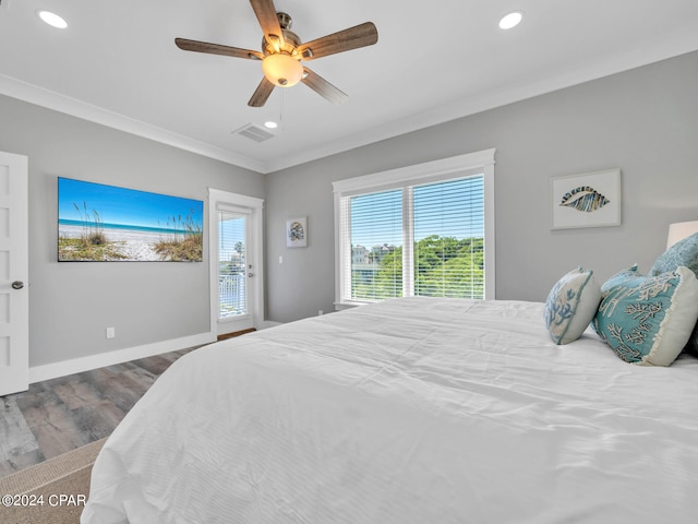 bedroom with hardwood / wood-style flooring, ceiling fan, and ornamental molding