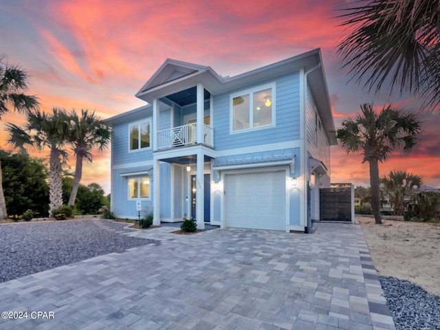 view of front of home with a balcony and a garage