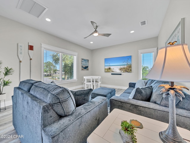 living room with ceiling fan and light wood-type flooring