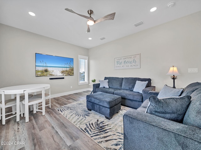 living room with ceiling fan and hardwood / wood-style floors