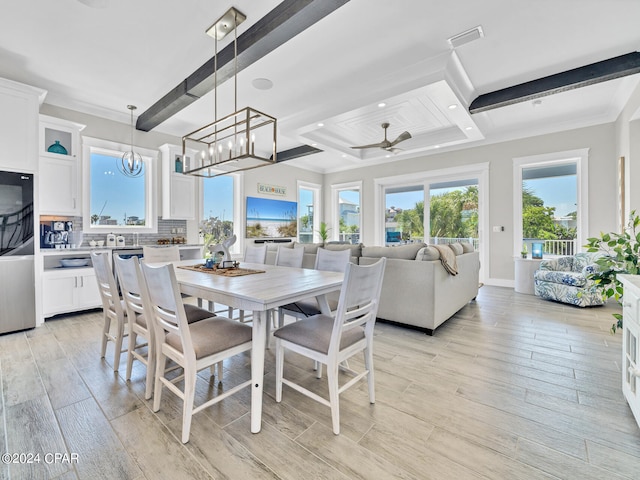 dining space featuring ceiling fan, light hardwood / wood-style flooring, beamed ceiling, and ornamental molding