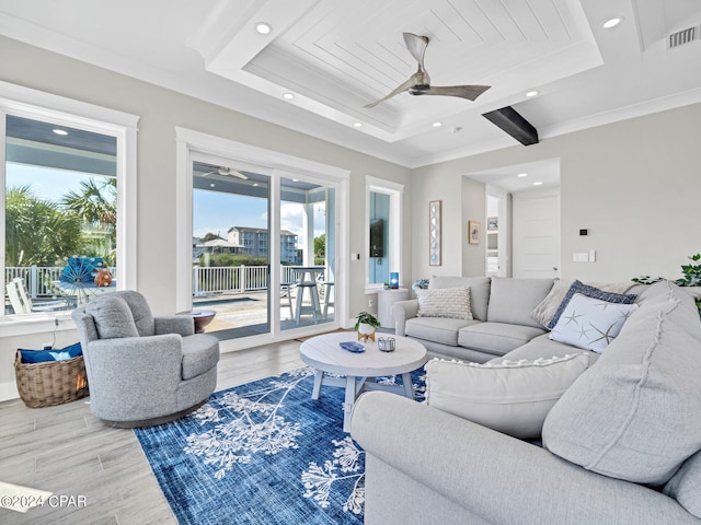 living room with ceiling fan, plenty of natural light, crown molding, and hardwood / wood-style flooring