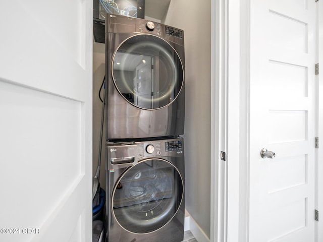 laundry area with stacked washing maching and dryer