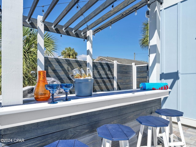 view of patio / terrace featuring a pergola and exterior bar