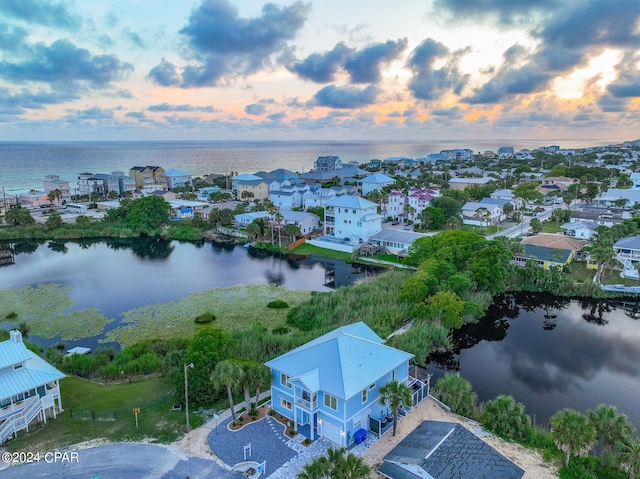 aerial view at dusk with a water view