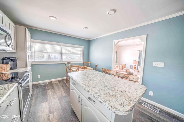 kitchen with stainless steel appliances, a center island, dark hardwood / wood-style floors, and white cabinets