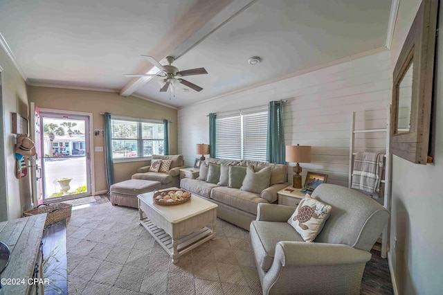 living room with light hardwood / wood-style floors, vaulted ceiling with beams, ornamental molding, and ceiling fan