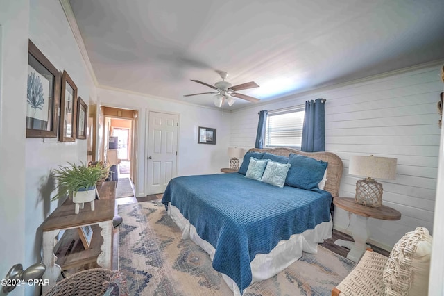 bedroom featuring ceiling fan, wood-type flooring, and crown molding