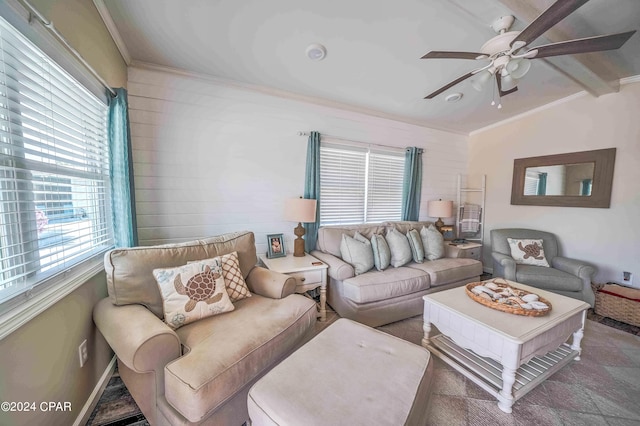 carpeted living room featuring vaulted ceiling with beams, ceiling fan, and crown molding