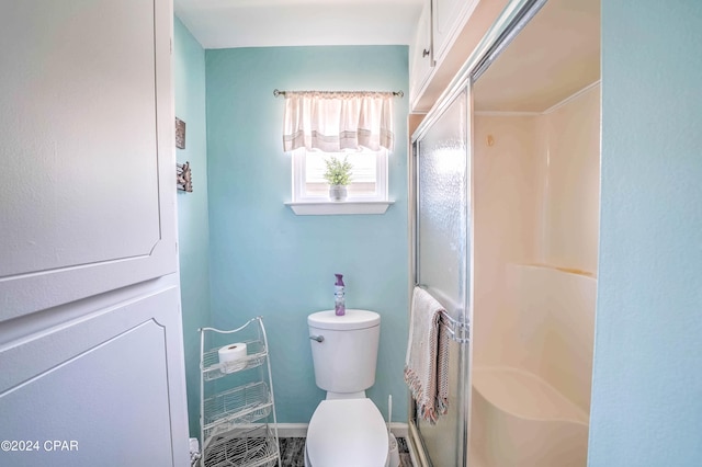 bathroom with toilet and an enclosed shower