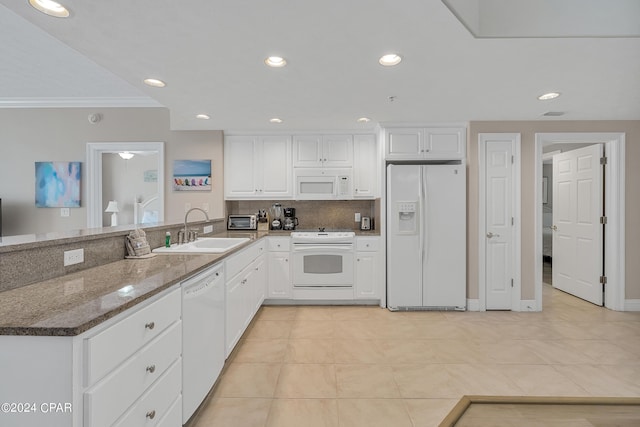 kitchen featuring sink, white appliances, white cabinets, and light tile patterned flooring