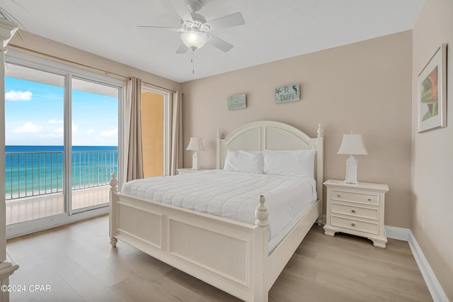 bedroom with ceiling fan, a water view, light hardwood / wood-style flooring, and access to outside