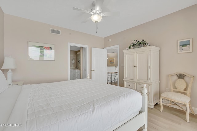 bedroom with connected bathroom, ceiling fan, and light hardwood / wood-style floors