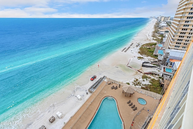 birds eye view of property featuring a water view and a view of the beach