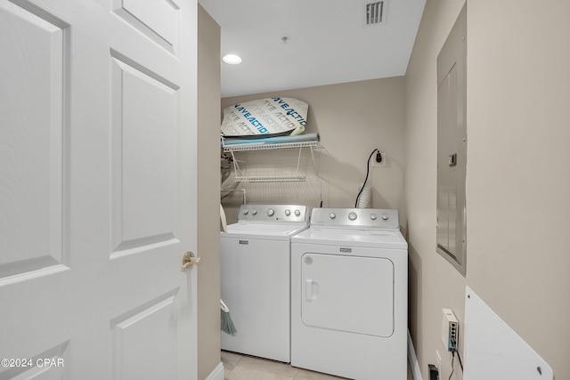 laundry area featuring light tile patterned floors and washing machine and clothes dryer