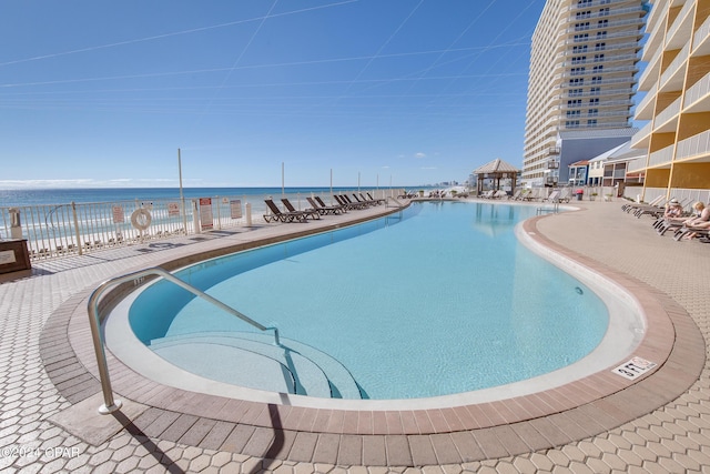 view of swimming pool with a water view