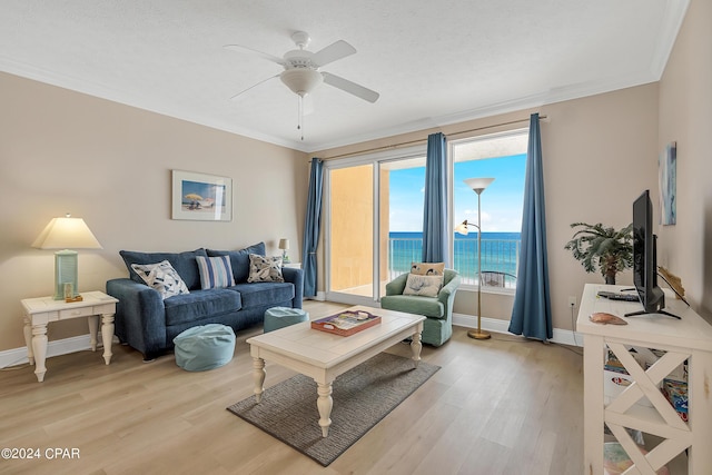 5004 Thomas Dr Unit 1209, Panama City Beach, FL 32408 - living area with baseboards, crown molding, light wood-style floors, and a ceiling fan