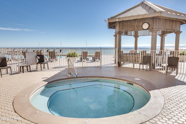 view of pool featuring a water view and a community hot tub