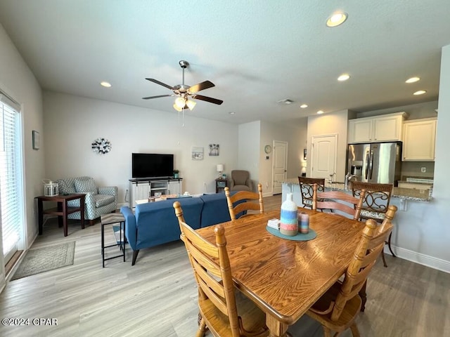 dining area featuring ceiling fan and light wood-type flooring