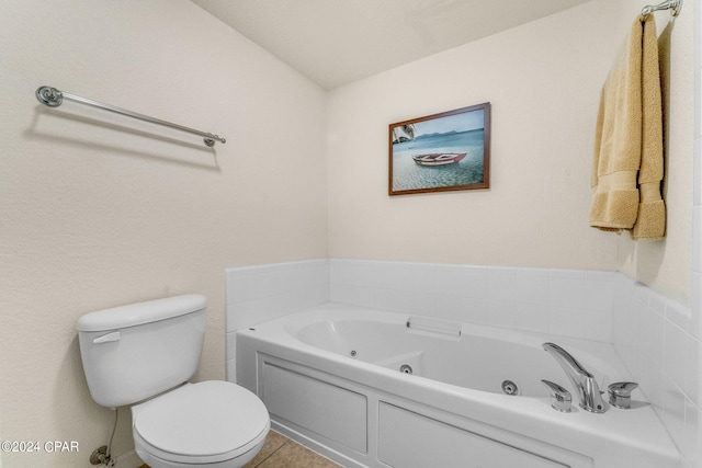 bathroom with a tub, tile floors, and toilet