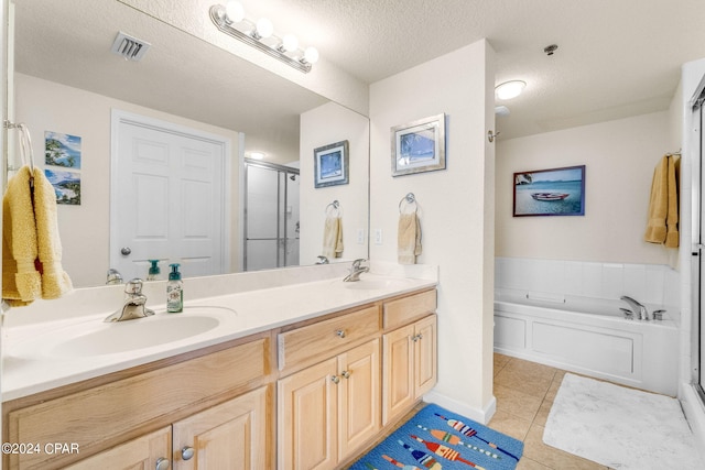 bathroom featuring shower with separate bathtub, a textured ceiling, dual bowl vanity, and tile flooring