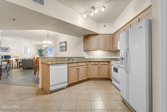 kitchen with kitchen peninsula, white appliances, a textured ceiling, and light stone countertops