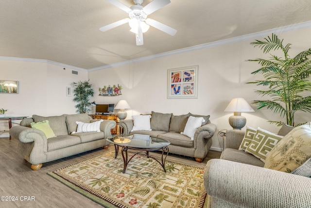 living room with ceiling fan, light hardwood / wood-style flooring, a textured ceiling, and crown molding