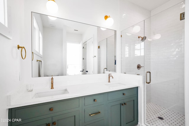 bathroom featuring a shower with door and vanity