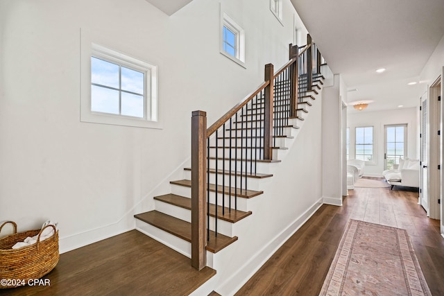 stairway featuring wood-type flooring