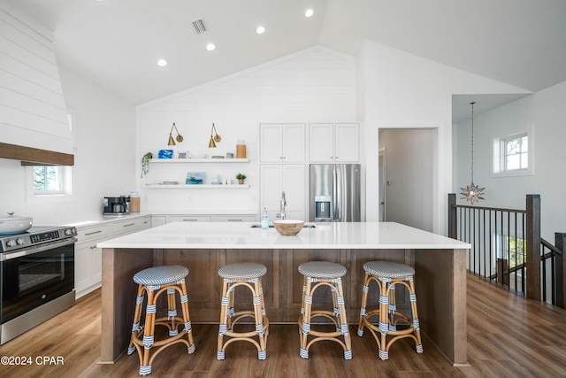 kitchen featuring a breakfast bar, a kitchen island, and appliances with stainless steel finishes