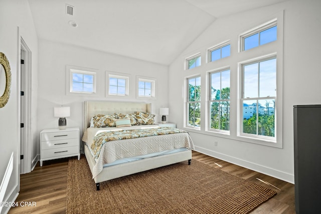 bedroom featuring dark hardwood / wood-style floors and lofted ceiling