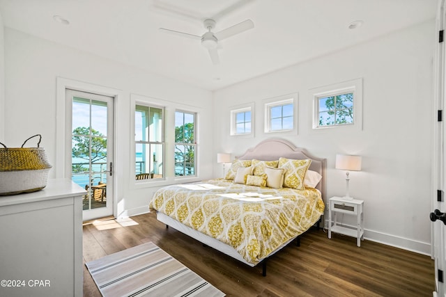 bedroom featuring ceiling fan, dark wood-type flooring, and access to outside